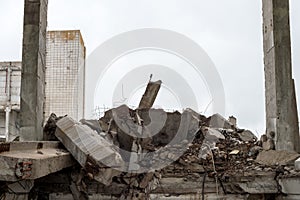 Large grey concrete fragments of a building with a lying beam in the foreground. Background.