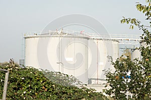 Large grey industrial tanks for petrol and oil storage