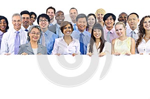 Large Group of Business People Holding Board