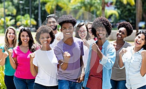 Large group of cheering african american and caucasian and hispanic and latin young adults