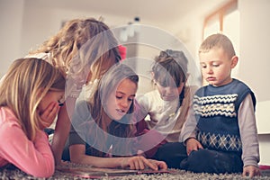 Large group of children lying on the floor.