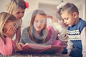 Large group of children lying on the floor.