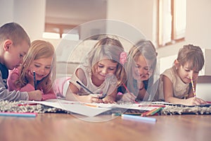 Large group of children lying on the floor.