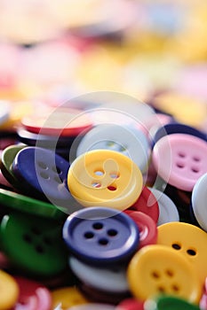 Large Group Of Colorful Plastic Sewing Buttons On Table