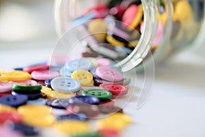 Large Group Of Colorful Plastic Sewing Buttons On Table