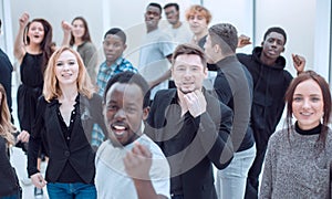 large group of diverse young people pointing at you.