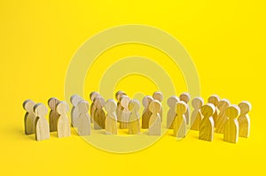 A large group of figurines of people on a yellow background. Social survey and public opinion, electorate. Population and citizens