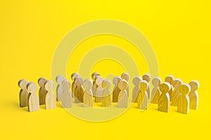 A large group of figurines of people on a yellow background. Social survey and public opinion, electorate. Population and citizens photo