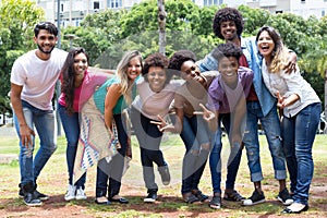 Large group of happy laughing international young adults photo