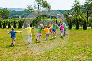 Large group of kids are holding hands and run