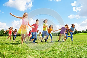 Large group of kids running in the park