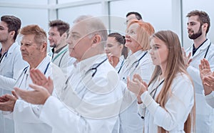 large group of medical practitioners applauding together.