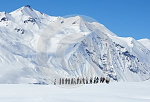 Large group of people from afar in mountains in winter