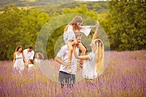 Large group of people in lavender field.