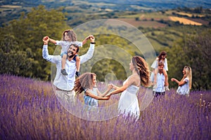 Large group of people in lavender field.