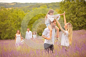 Large group of people in lavender field. Focus is on foreground