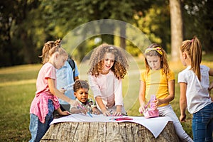 Large group of people writing together in the park