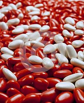 Large group of red and white candy-coated almonds still life