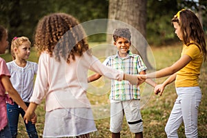 Large group of school kids having fun in nature.