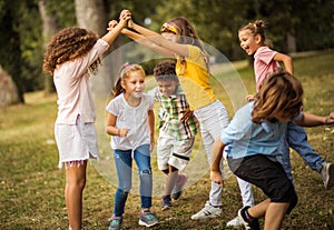 Large group of school kids having fun in nature.