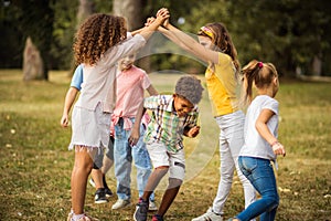 Large group of school kids having fun in nature Playing time