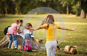 Large group of school kids in nature. Portrait of school girl Dancing girl