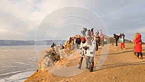 A large group of tourists on Cape Burkhan at the Shamanka rock on the island of Olkhon in Russia in anticipation of sunset