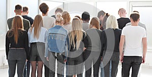 large group of young people looking at a large white screen