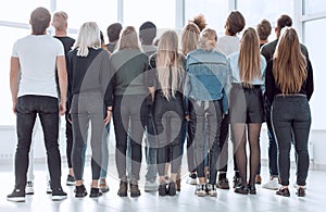 large group of young people looking at a large white screen