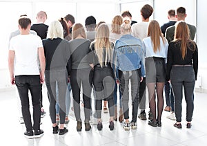 large group of young people looking at a large white screen