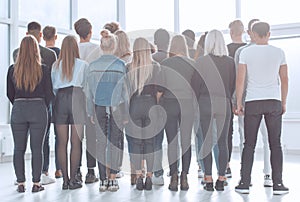 large group of young people looking at a large white screen