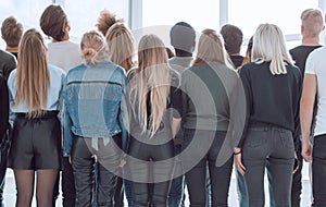 large group of young people looking at a large white screen