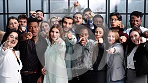 Large group of young people pointing at you.