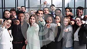 Large group of young people pointing at you.