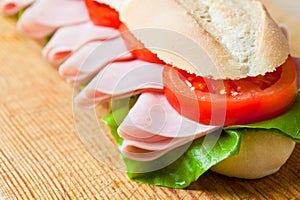 A large ham and tomato baguette