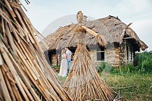 Large handmade doll amulet near a wooden house photo