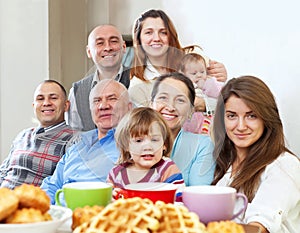 Large happy family having tea