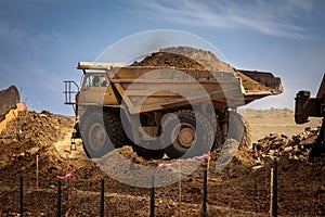 large haul dump truck at a construction site filled with dirt