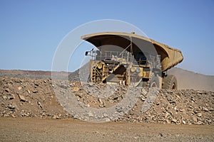 A large haul truck leaving with dirt