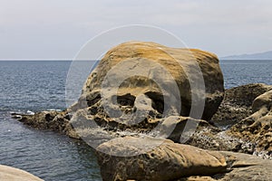 Large head-shaped rock in the seashore of Yehliu