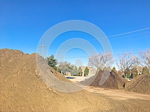 Large heap of organic topsoil pile at wholesale compost plant near Dallas, Texas