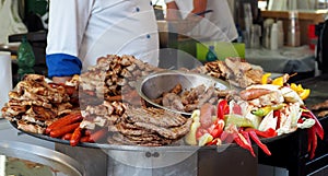 Large heated tray with the traditional serbian street food. The typical grilled meats with vegetables photo