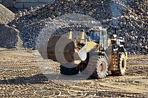 Large heavy front-end loader or all-wheel bulldozer for mechanization of loading, digging and excavation operations in open quarry photo