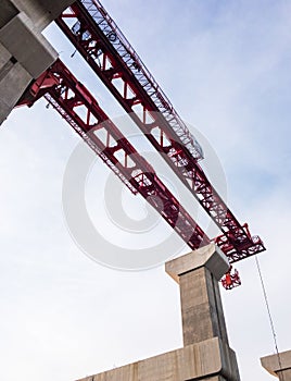 Large high crane on the concrete pillar.