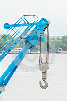 Large hook construction crane on the background