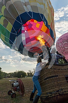 a large hot air balloon being lifted from the ground by people