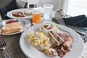 Large hot breakfast with scrambled eggs, bacon