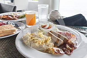 Large hot breakfast with scrambled eggs, bacon