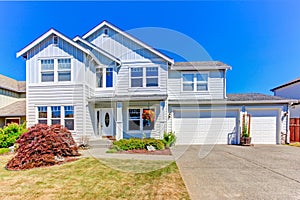 Large house exterior. Driveway and front yard view