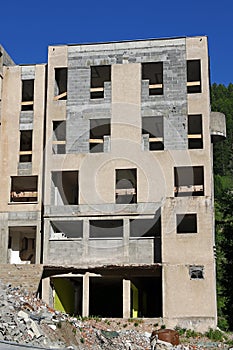 A large house is partly demolished and rebuilt